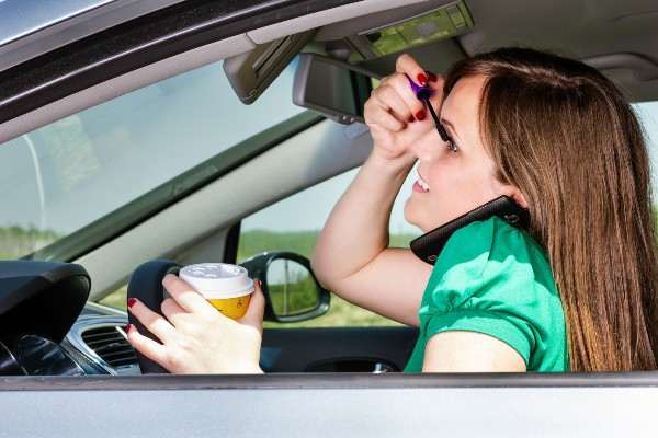 Distracted driver drinks coffee and puts make up on in Denver 