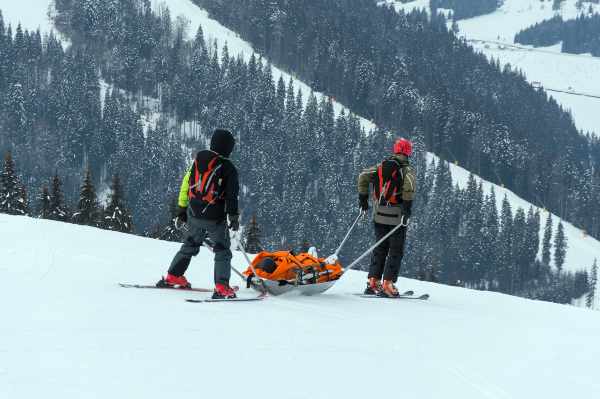 A rescue team helps injured skier after a fall in a Denver slope