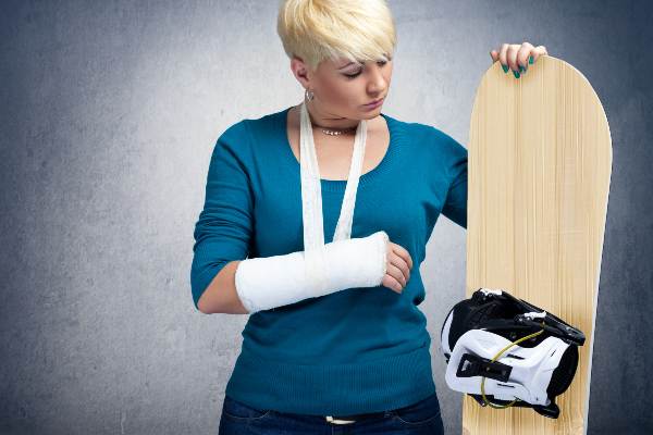 Female snowboarder has a broken arm form a fall 